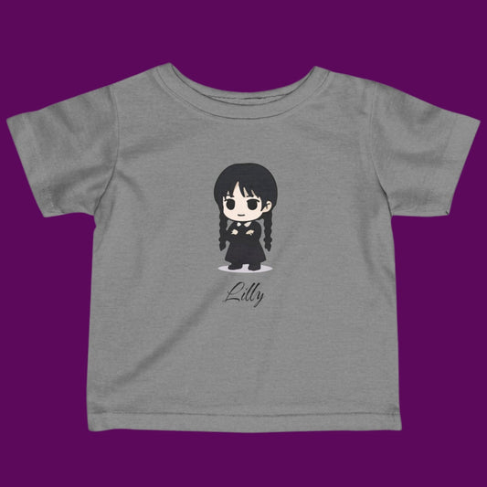 Custom Chibi Wednesday Addams inspired goth girl graphic with a personalized name on a gray kids t-shirt. Available in The Fright Factory New Orleans gift shop.